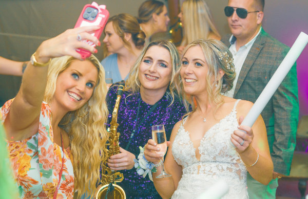 Clare with a bride at an evening wedding reception