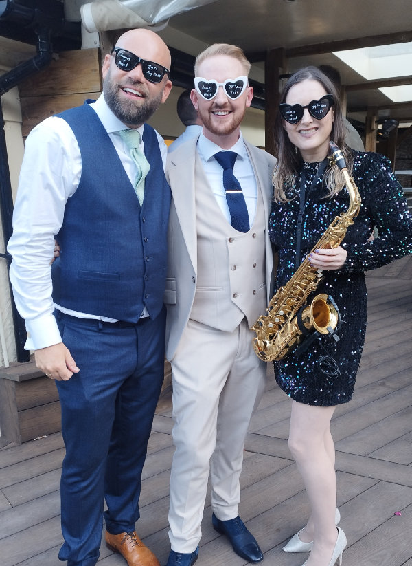 Clare playing saxophone at a wedding