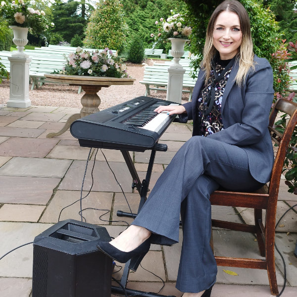 Clare playing piano for a wedding ceremony